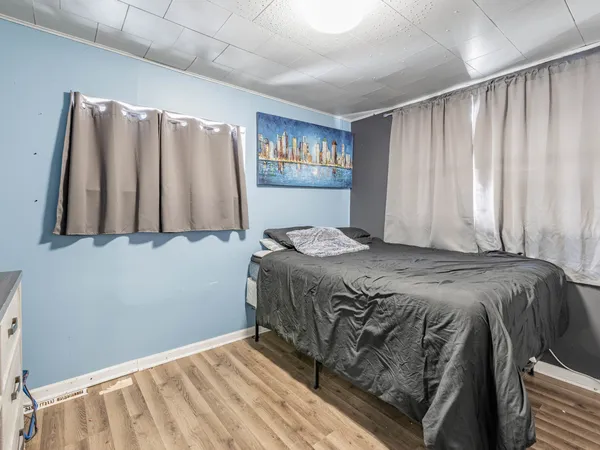 a bedroom with a bed and a night stand