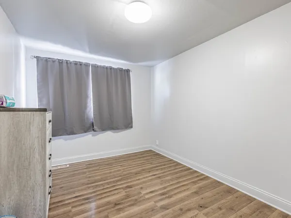 a view of wooden floor and windows in a room