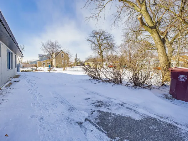 a view of a house with a snow in the yard