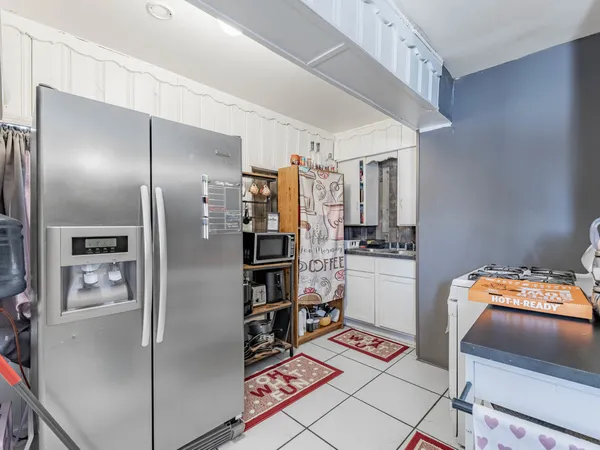 a kitchen with stainless steel appliances a refrigerator and a stove top oven