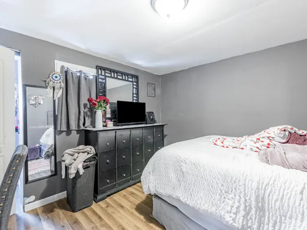 a bedroom with a bed and a flat screen tv