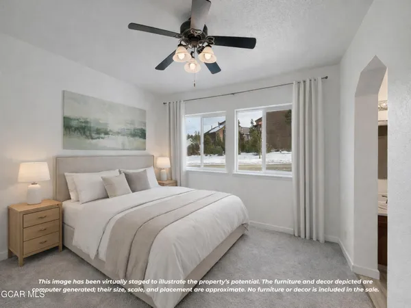 a bedroom with a large bed and a chandelier