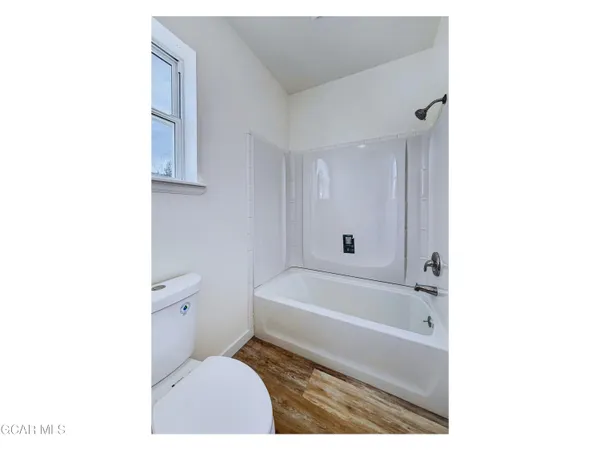 a bathroom with a toilet and a bathtub