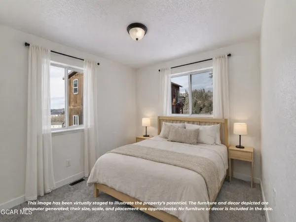 a bedroom with a large bed and a window