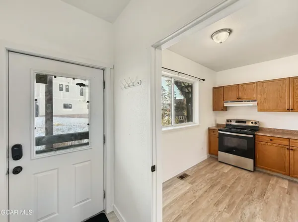a kitchen with stainless steel appliances granite countertop a stove and a refrigerator