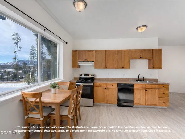 a kitchen with stainless steel appliances granite countertop a stove a sink and a granite counter tops with wooden floors