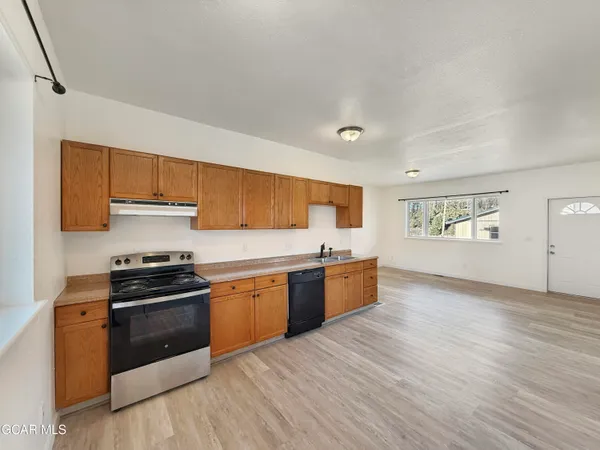 a kitchen with granite countertop a stove and a sink