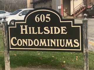 605 North Wolf Road, Unit C5 Hillside, IL 60162 - Photo 1 of 1 a sign broad on wooden wall