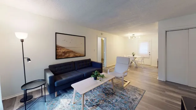 a living room with furniture and wooden floor