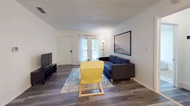 a living room with furniture fireplace and flat screen tv