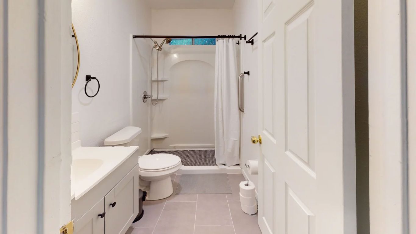 1109 Gardner Cove Austin, TX 78721 - Photo 5 of 12 a bathroom with a sink a toilet and shower