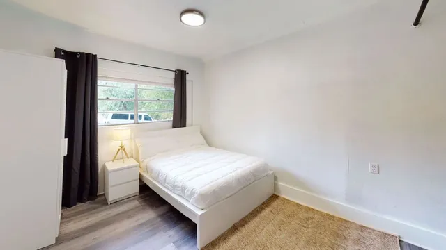 a bedroom with a bed and a window