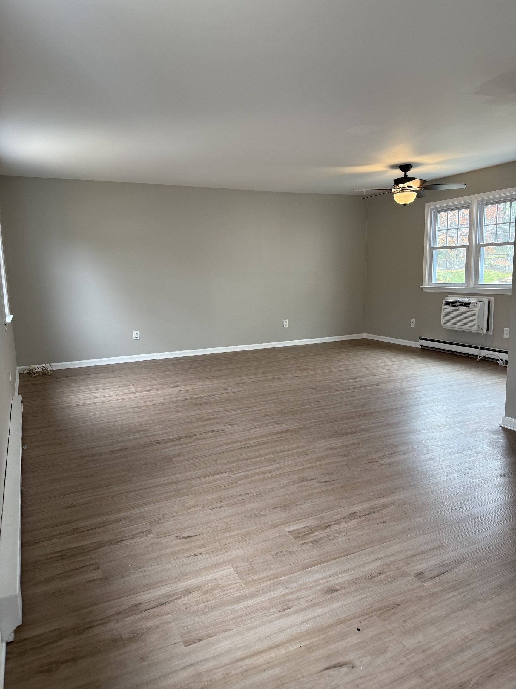 2 Frances Avenue, Unit 2 Norwalk, CT 06854 - Photo 2 of 9 a view of empty room with wooden floor and fan