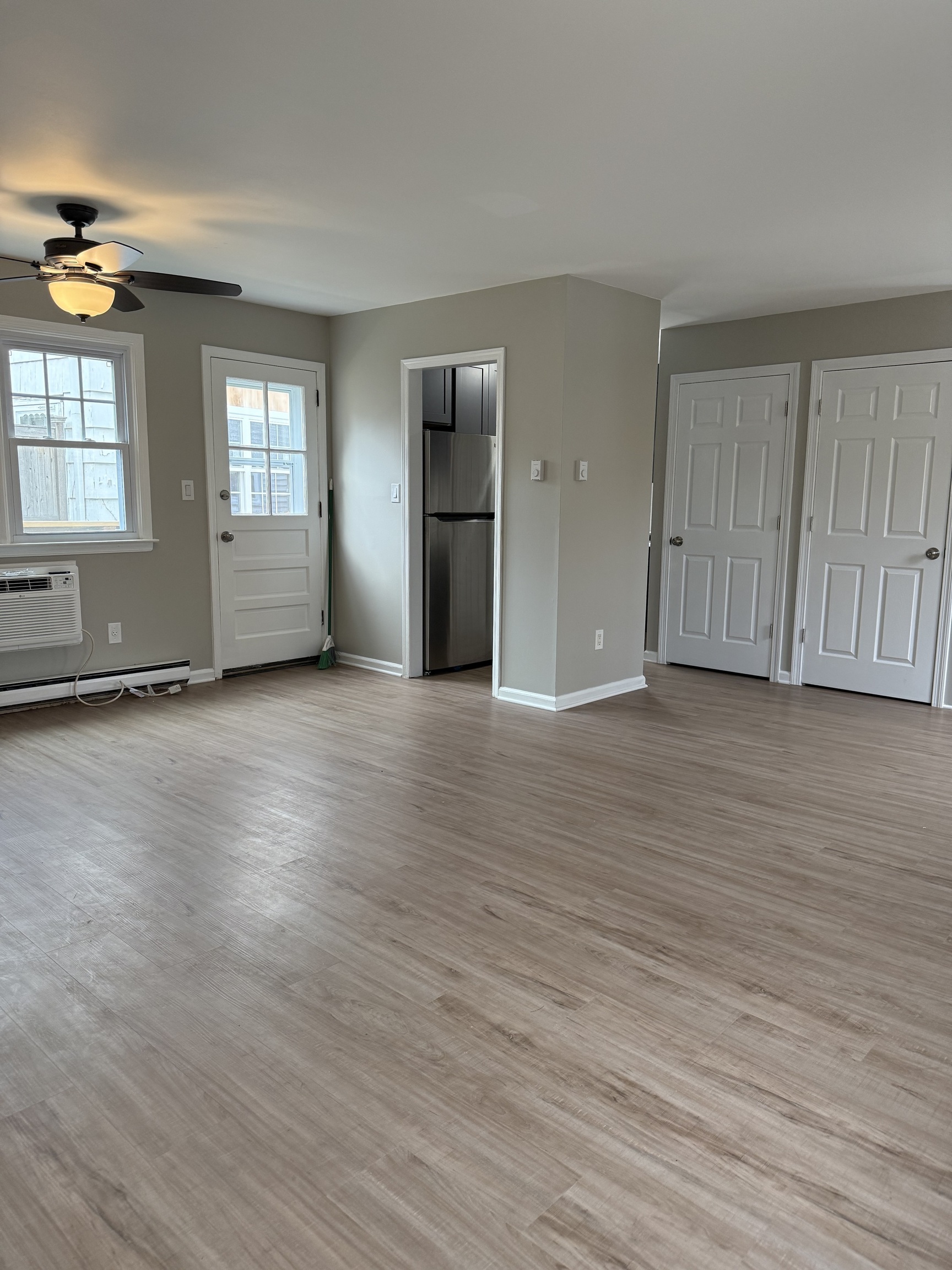 2 Frances Avenue, Unit 2 Norwalk, CT 06854 - Photo 3 of 9 an empty room with wooden floor and windows
