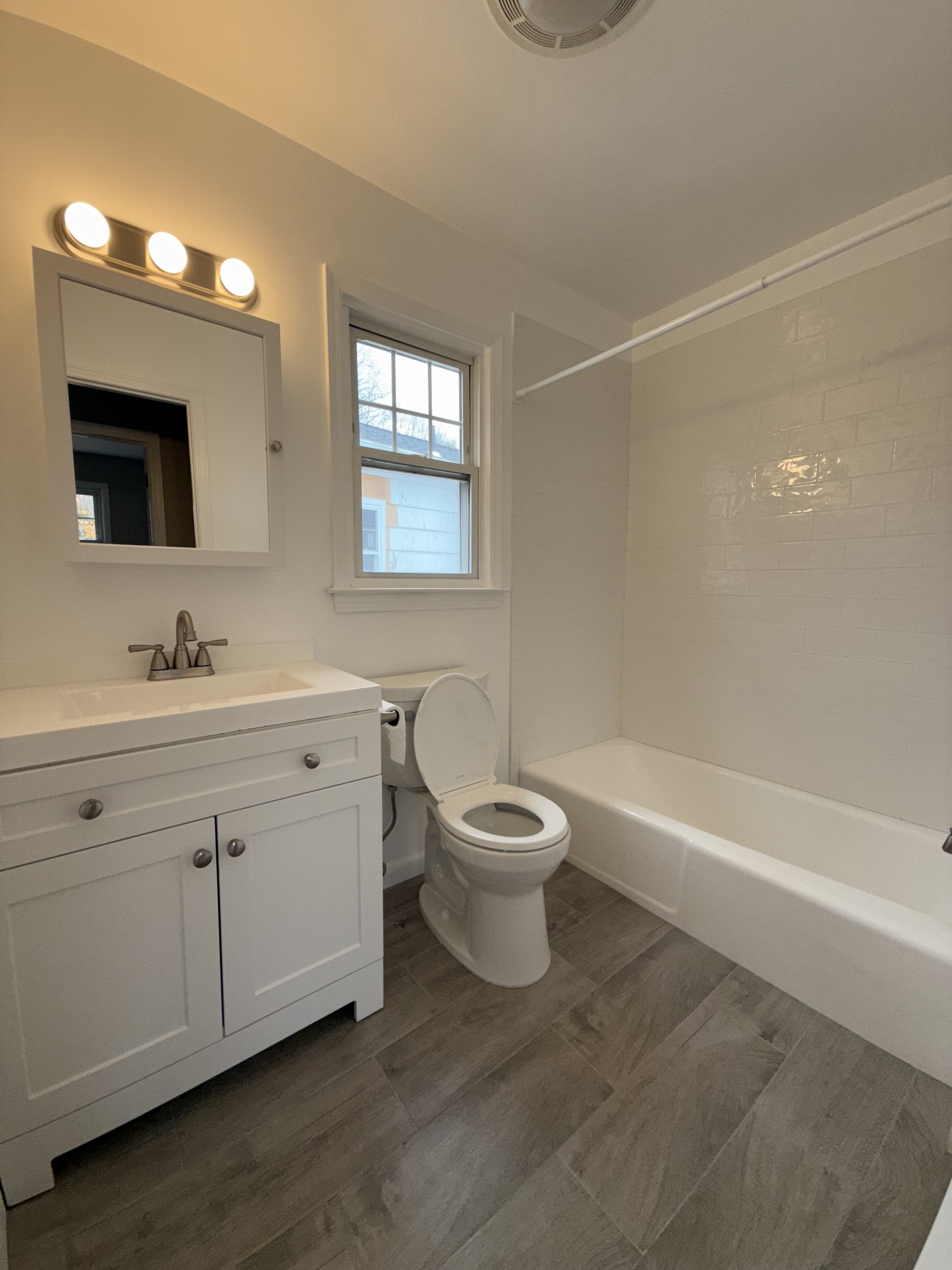 2 Frances Avenue, Unit 2 Norwalk, CT 06854 - Photo 9 of 9 a bathroom with a double vanity sink a toilet and a bathtub