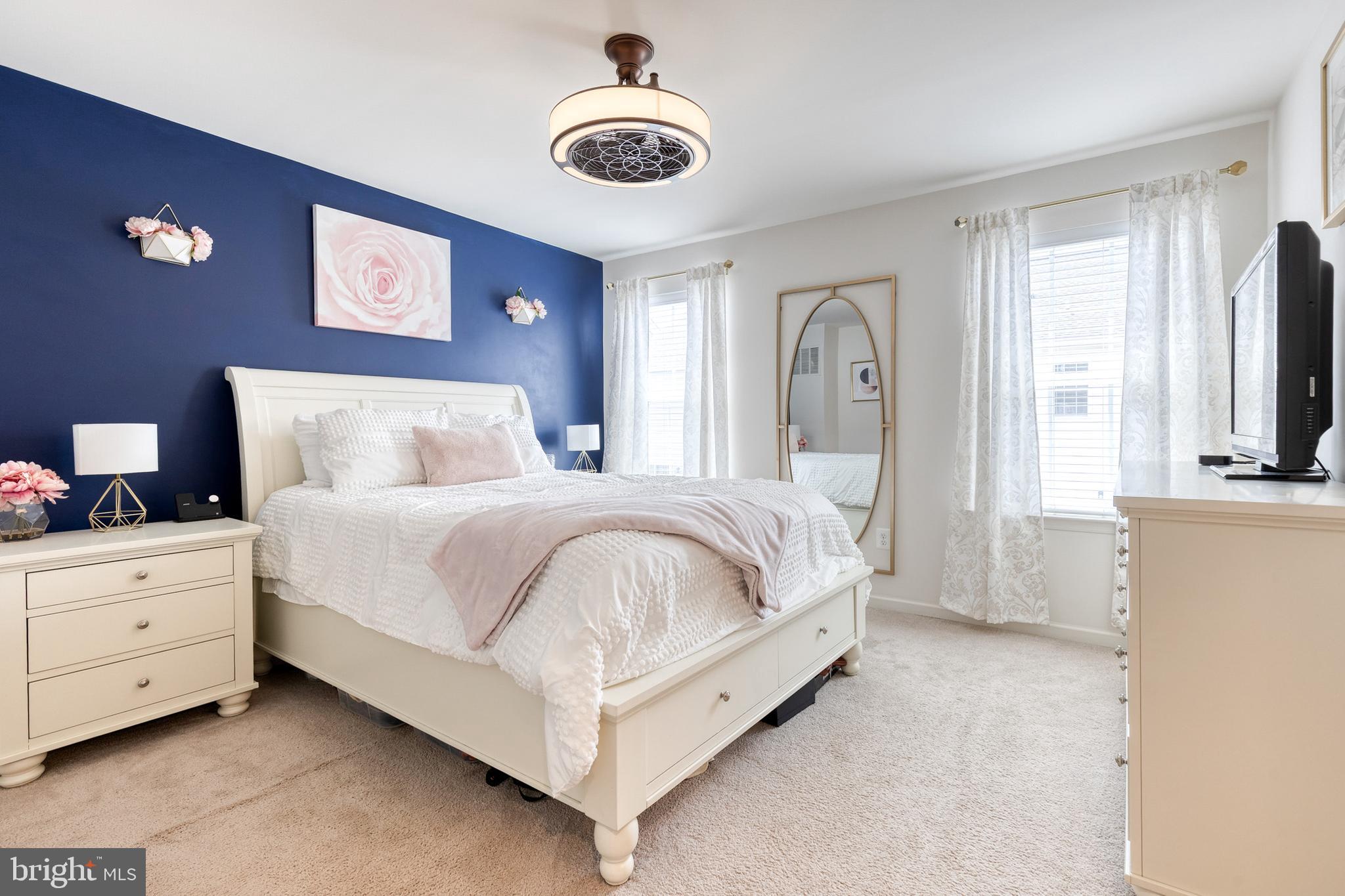 906 Sandy Run Road Baltimore, MD 21220 - Photo 17 of 31 a bedroom with a large bed and a chandelier