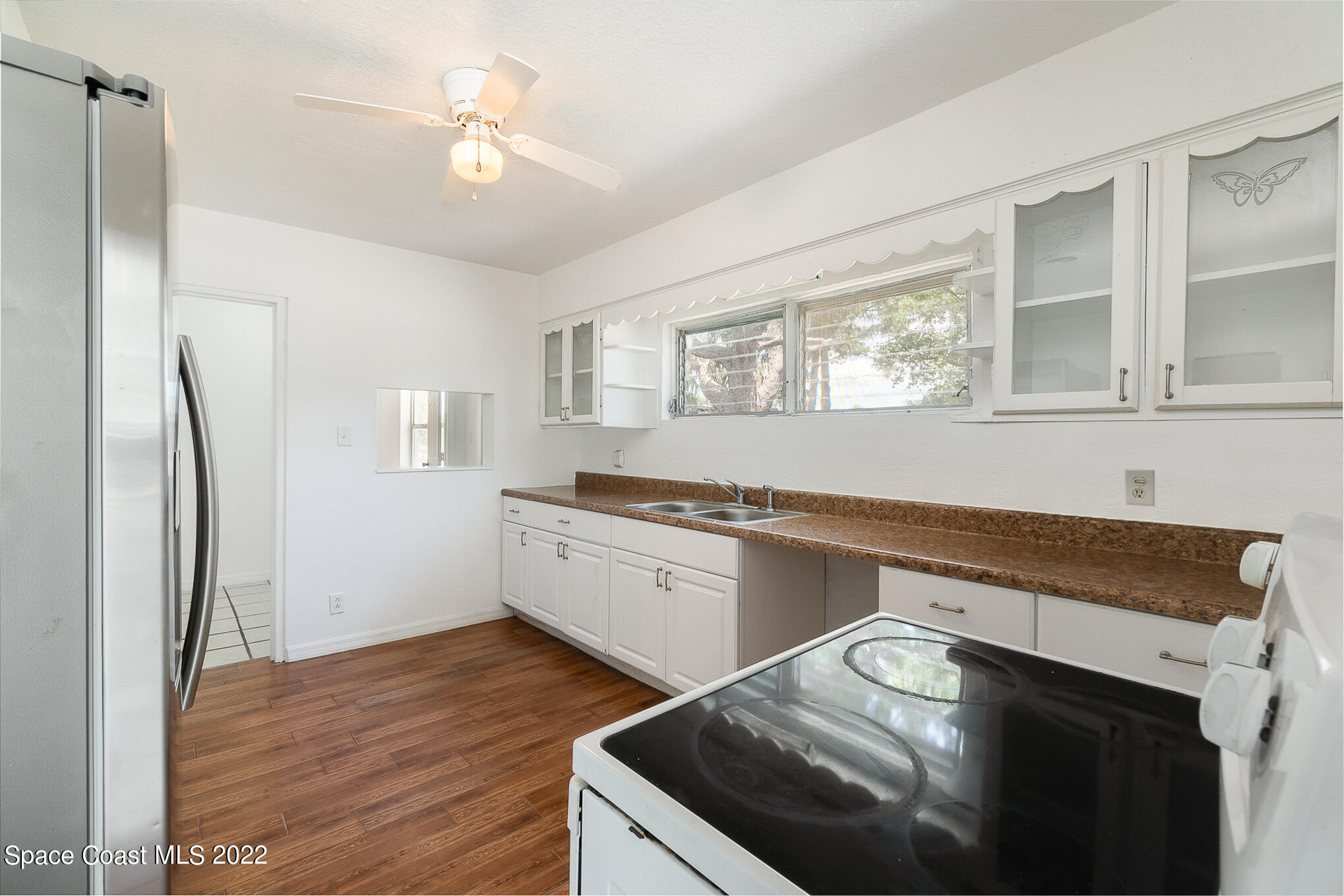 150 Capron Road Cocoa, FL 32927 - Photo 3 of 20 a kitchen with granite countertop a sink stainless steel appliances and cabinets