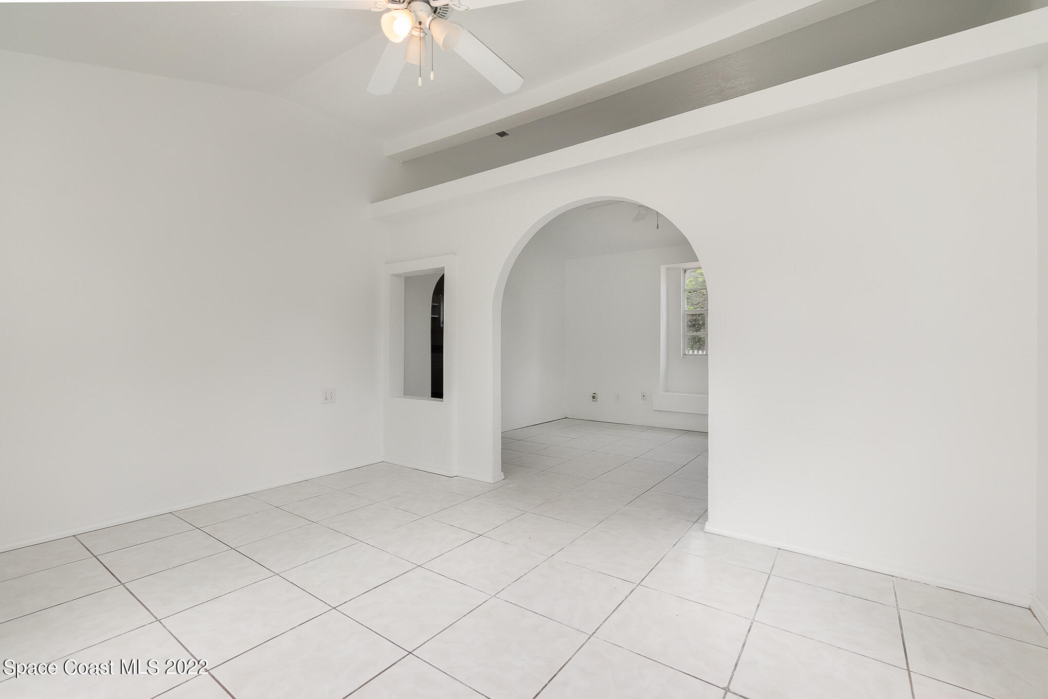 150 Capron Road Cocoa, FL 32927 - Photo 8 of 20 an empty room with a chandelier fan