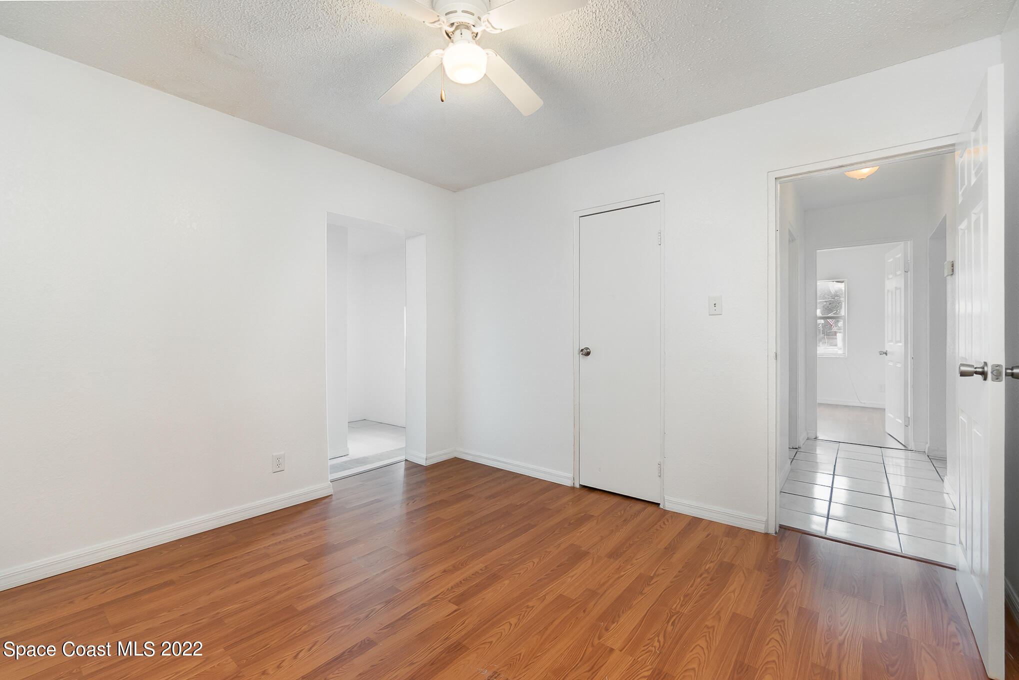 150 Capron Road Cocoa, FL 32927 - Photo 9 of 20 an empty room with wooden floor and mirror