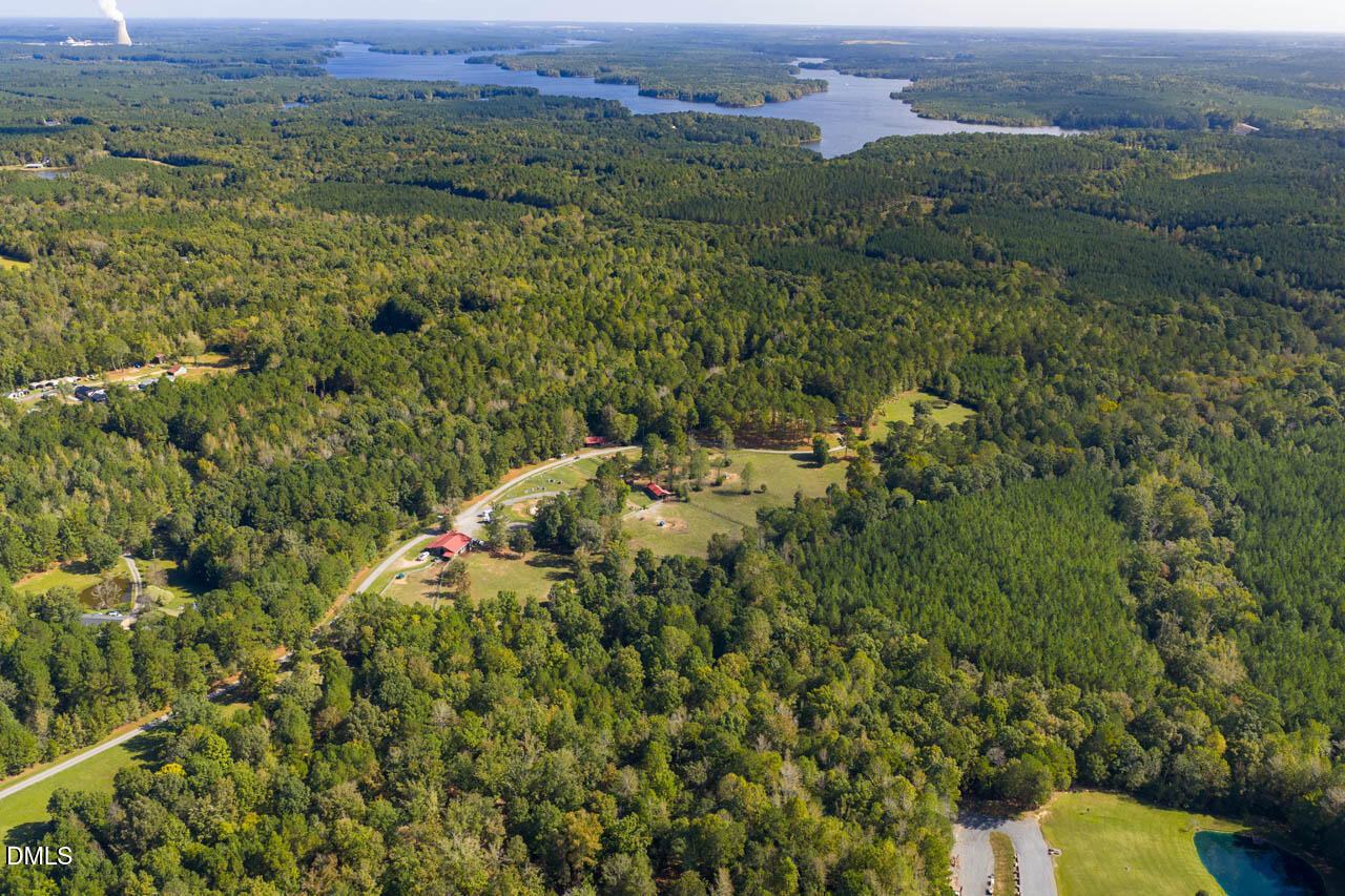 262 Ellis Road Moncure, NC 27559 - Photo 14 of 29 an aerial view of a houses with a lush green hillside