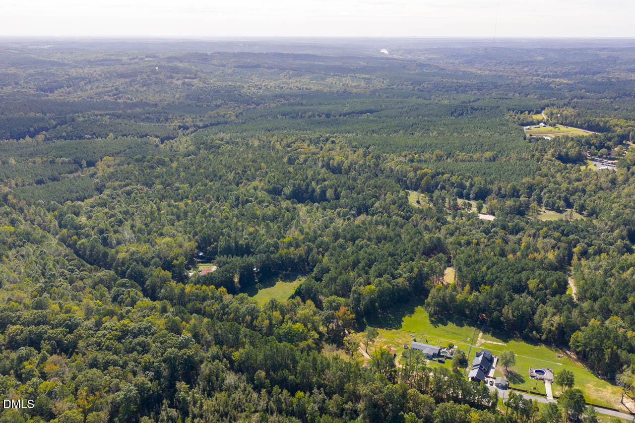 262 Ellis Road Moncure, NC 27559 - Photo 6 of 29 a view of a green field with lots of bushes