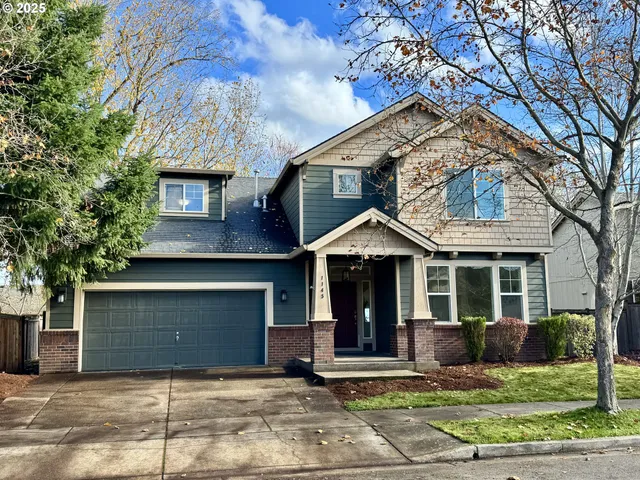 a backyard of a house with plants and tree