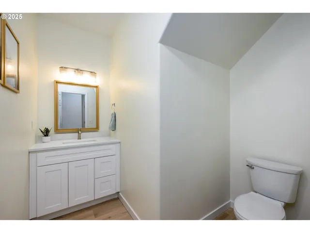 a view of kitchen with cabinets and refrigerator