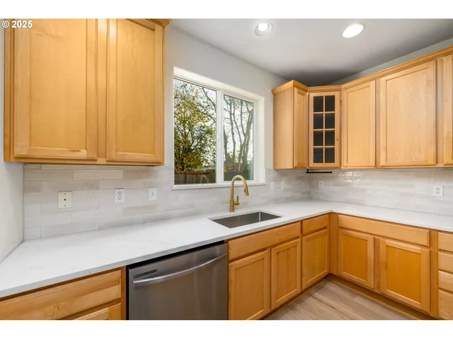 a kitchen with sink cabinets and wooden floor