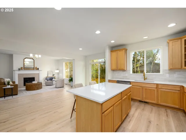 a kitchen with a refrigerator and a stove top oven