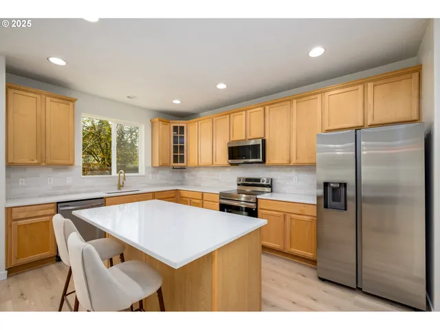 a view of a livingroom with wooden floor and a ceiling fan