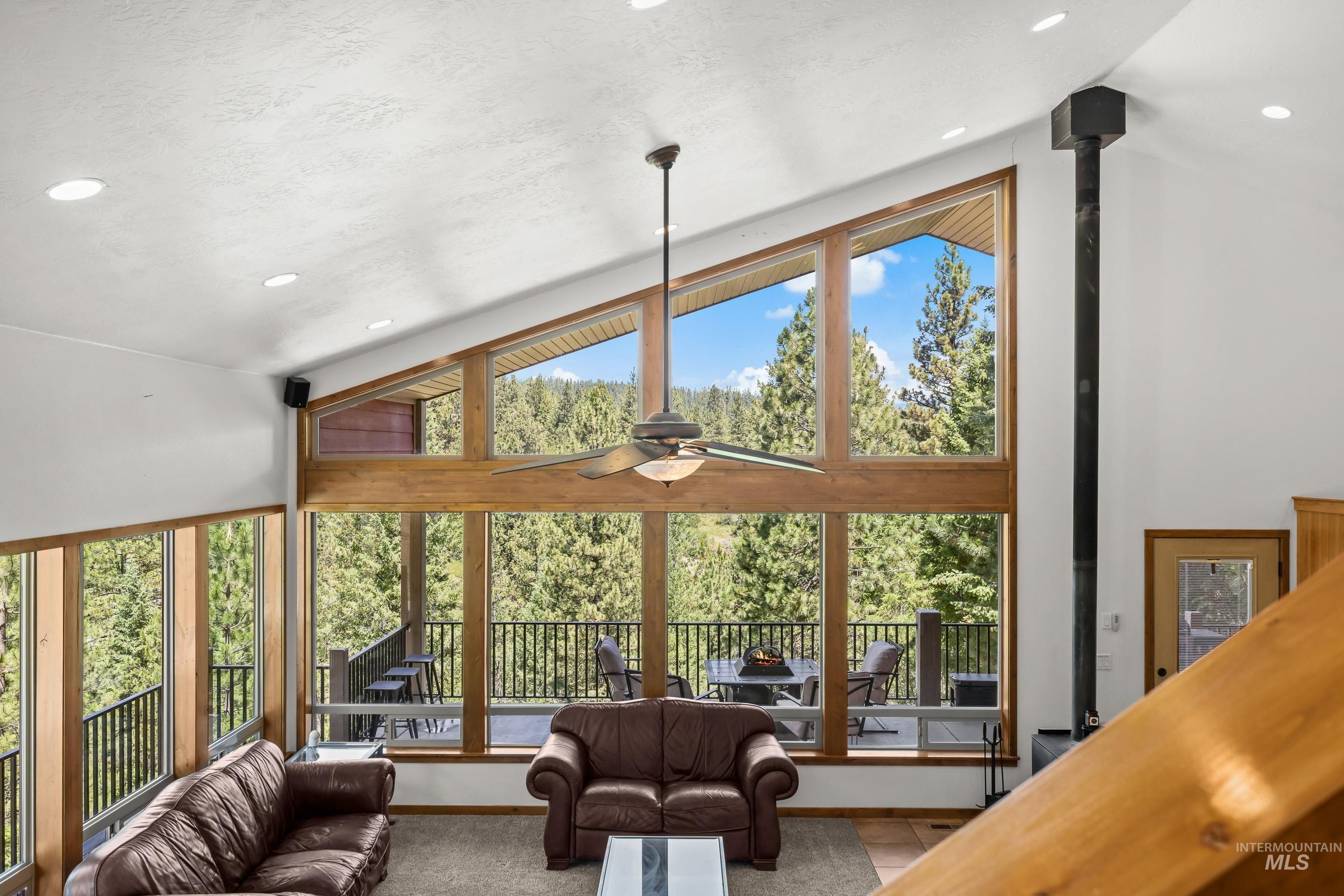 92 Cruickshank Road Horseshoe Bend, ID 83629 - Photo 38 of 50 Vaulted ceiling living space featuring expansive wood-trimmed windows, recessed lighting, and a ceiling fan