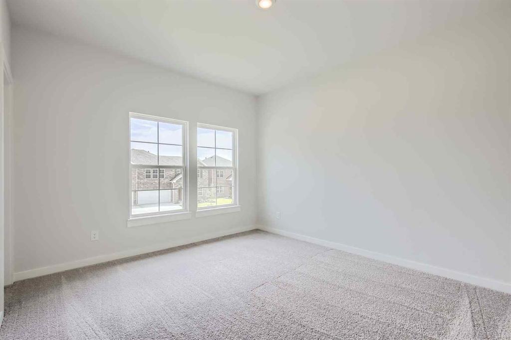 736 Vineyard Way Forney, TX 75126 - Photo 16 of 40 an empty room with a window
