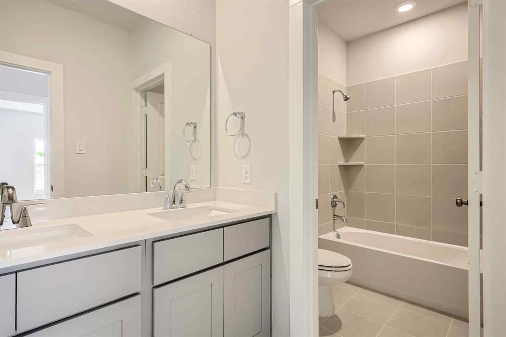 736 Vineyard Way Forney, TX 75126 - Photo 17 of 40 a bathroom with a sink a toilet and shower