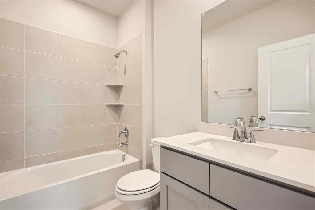 736 Vineyard Way Forney, TX 75126 - Photo 21 of 40 a bathroom with a granite countertop sink a toilet and shower