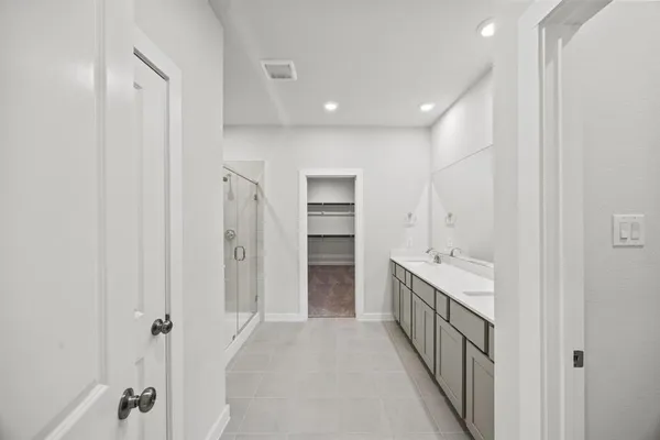 a bathroom with a double vanity sink and a mirror