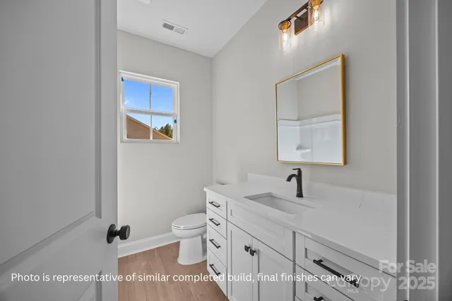 a hallway with white walls and stairs