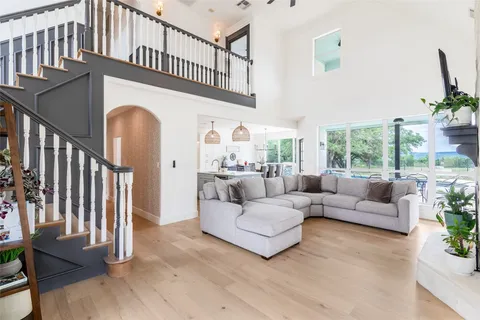 a kitchen with stainless steel appliances a sink a stove and chairs