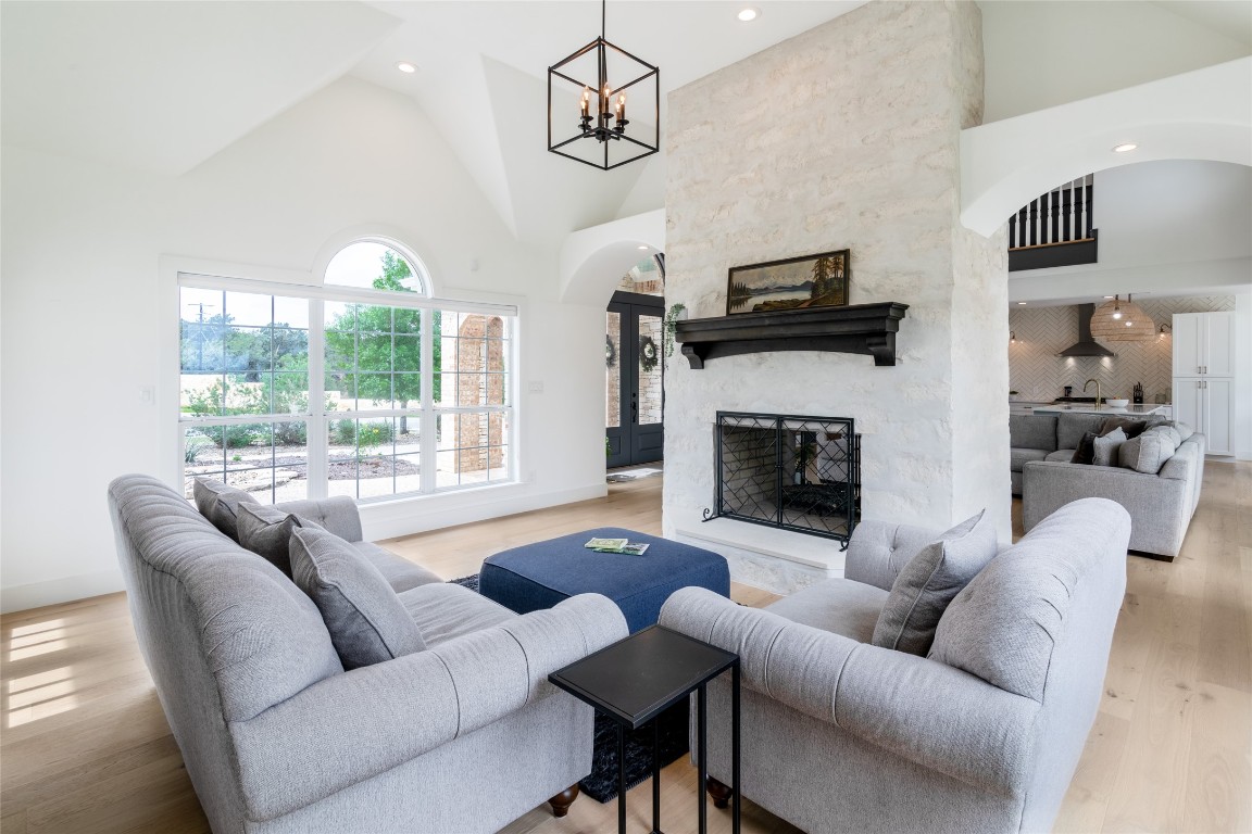31 West Valley Spring Road Wimberley, TX 78676 - Photo 15 of 38 a living room with furniture a flat screen tv and a fireplace