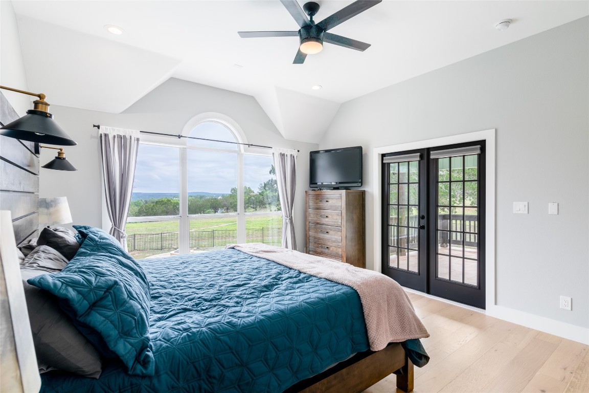 31 West Valley Spring Road Wimberley, TX 78676 - Photo 17 of 38 a bed sitting in a bedroom next to a window