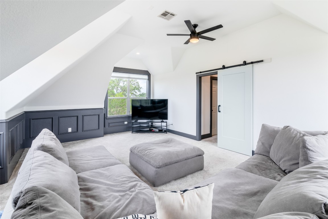 31 West Valley Spring Road Wimberley, TX 78676 - Photo 21 of 38 a living room with furniture and a flat screen tv