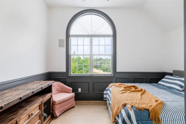 a bedroom with bed and a window