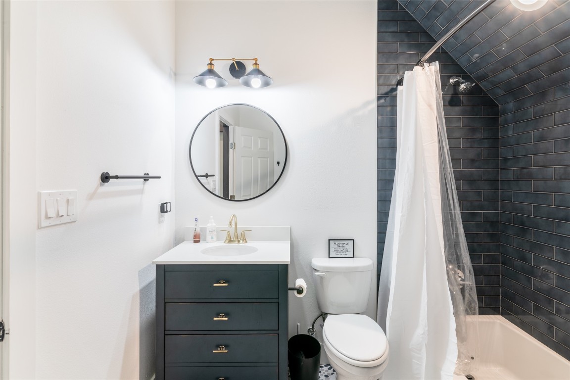 31 West Valley Spring Road Wimberley, TX 78676 - Photo 24 of 38 a bathroom with a sink vanity mirror and toilet