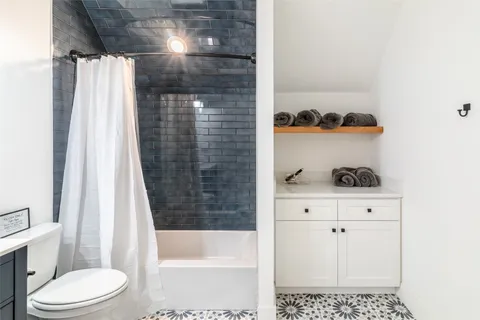 a bathroom with a bathtub and a shower