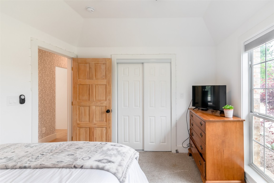 31 West Valley Spring Road Wimberley, TX 78676 - Photo 27 of 38 a bedroom with a bed and flat screen tv