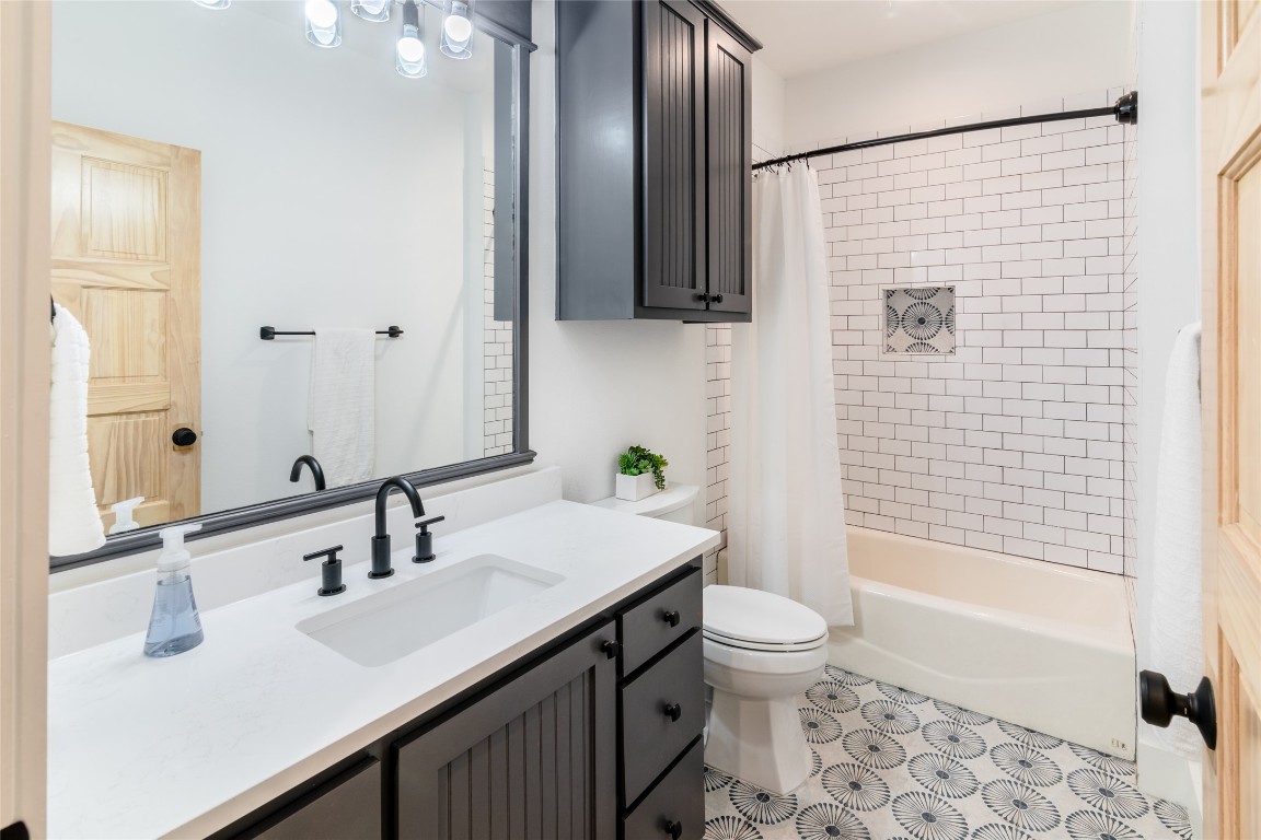 31 West Valley Spring Road Wimberley, TX 78676 - Photo 28 of 38 a bathroom with a sink a toilet and shower