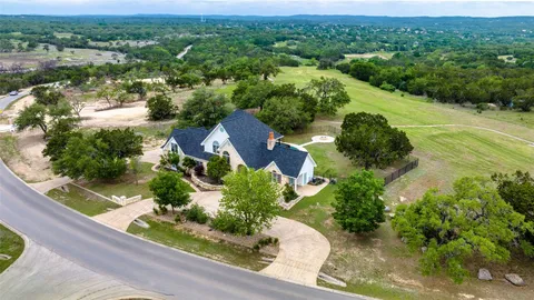 an aerial view of green landscape with trees houses and mountain view