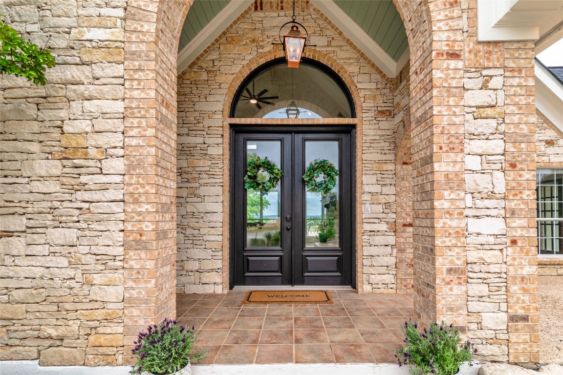 31 West Valley Spring Road Wimberley, TX 78676 - Photo 6 of 38 a view of a brick house with large windows