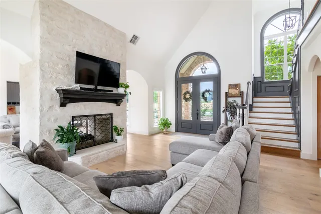 a living room with furniture a flat screen tv and a fireplace