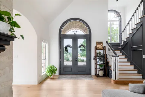 a living room with furniture a window and wooden floor