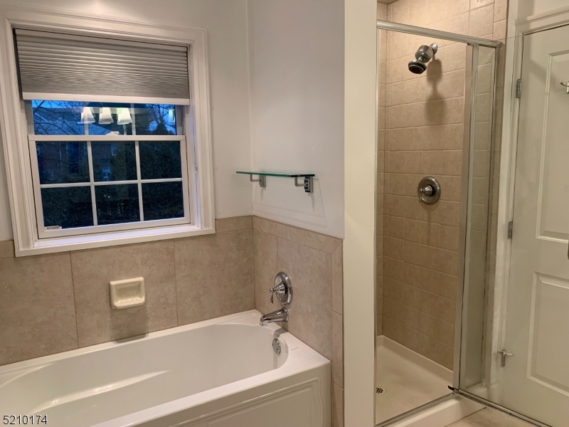 453 Springfield Avenue Berkeley Heights, NJ 07922 - Photo 11 of 13 a bathroom with a bathtub and shower